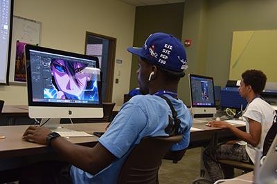 Graphic design students completing their assignments in class