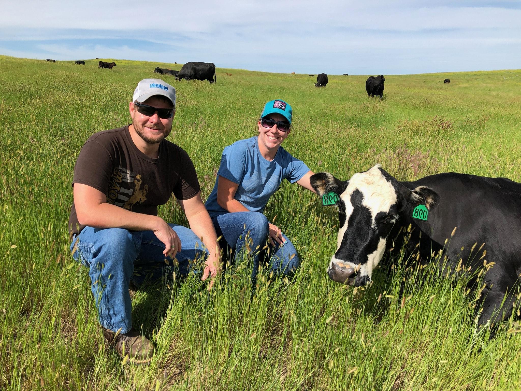 Student and instructor are in a field with livestock