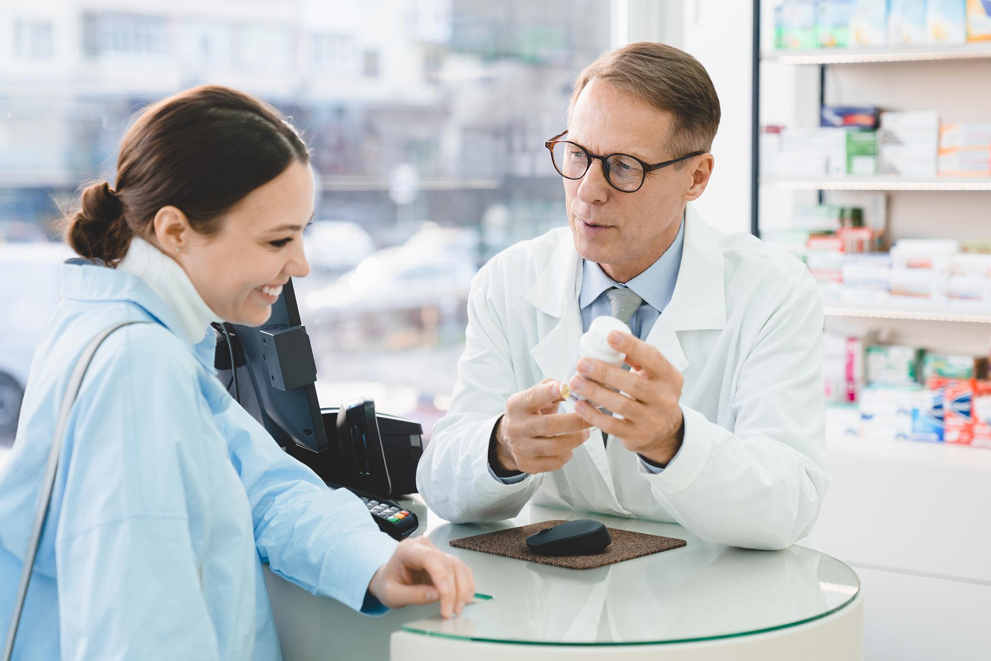 Pharmacist explaining a drug to a patient.