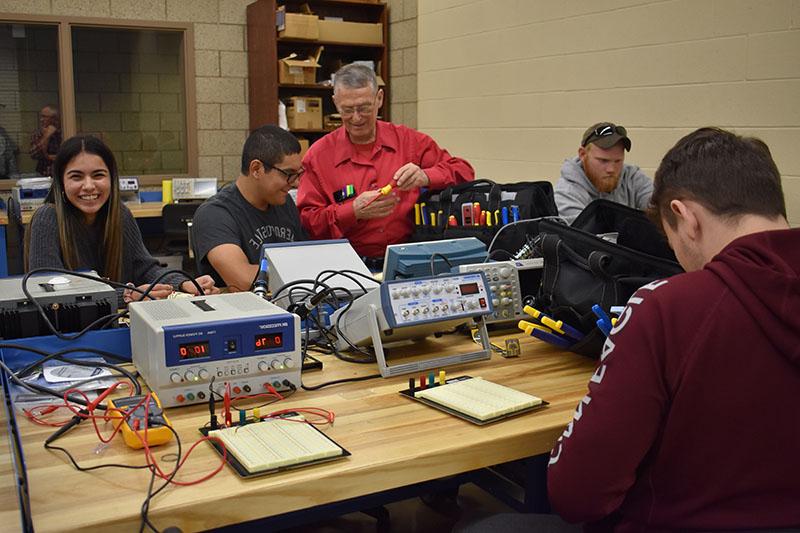 Electronics lab instructor and students.