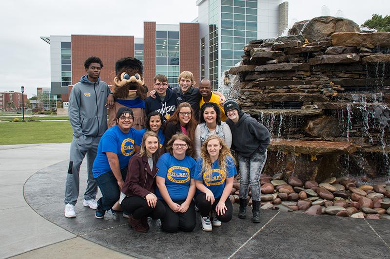 Students and Trailblazer Willie are standing by the fountain on Vincennes' Campus